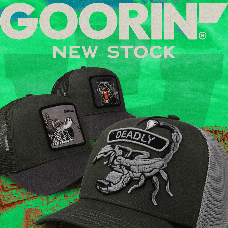 Three black trucker hats with embroidered patches are displayed against a green textured background with 'GOORIN NEW STOCK' text at the top and '2CAP' branding at the bottom.